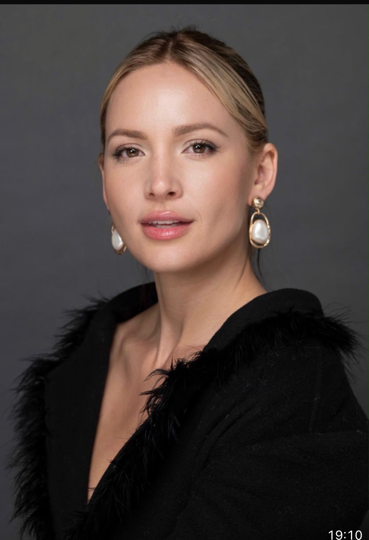 Alina Nastase editorial portrait in black with feathered shoulders